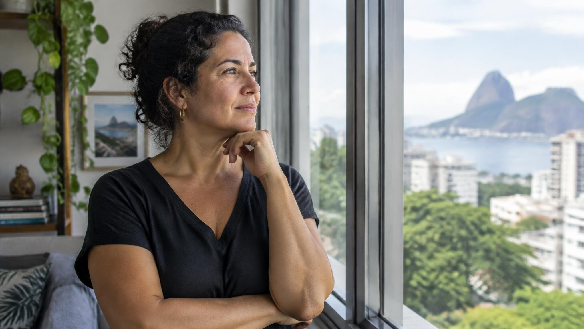 Person looking thoughtfully out of a large window
